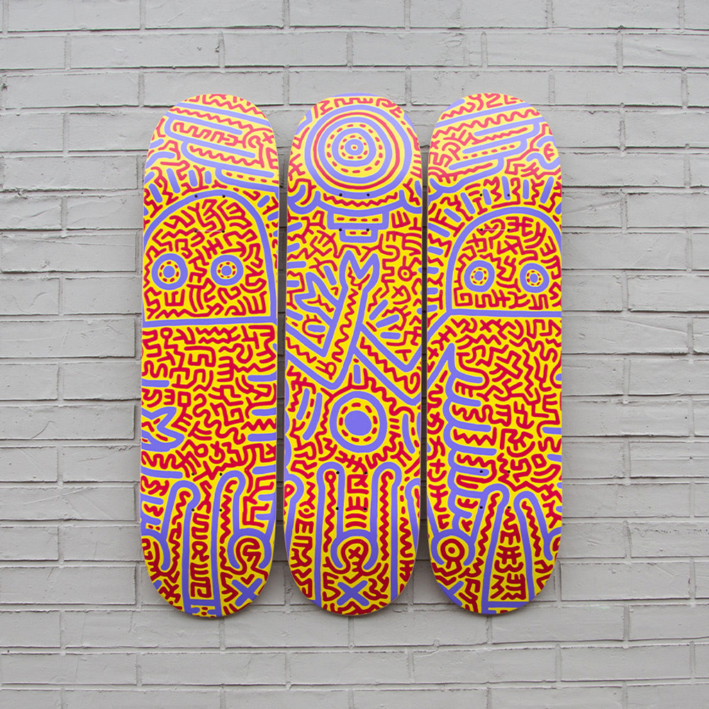 Triptych skateboards on brick wall.