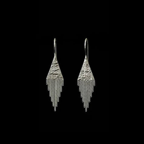 Pair of silver earrings on a black background