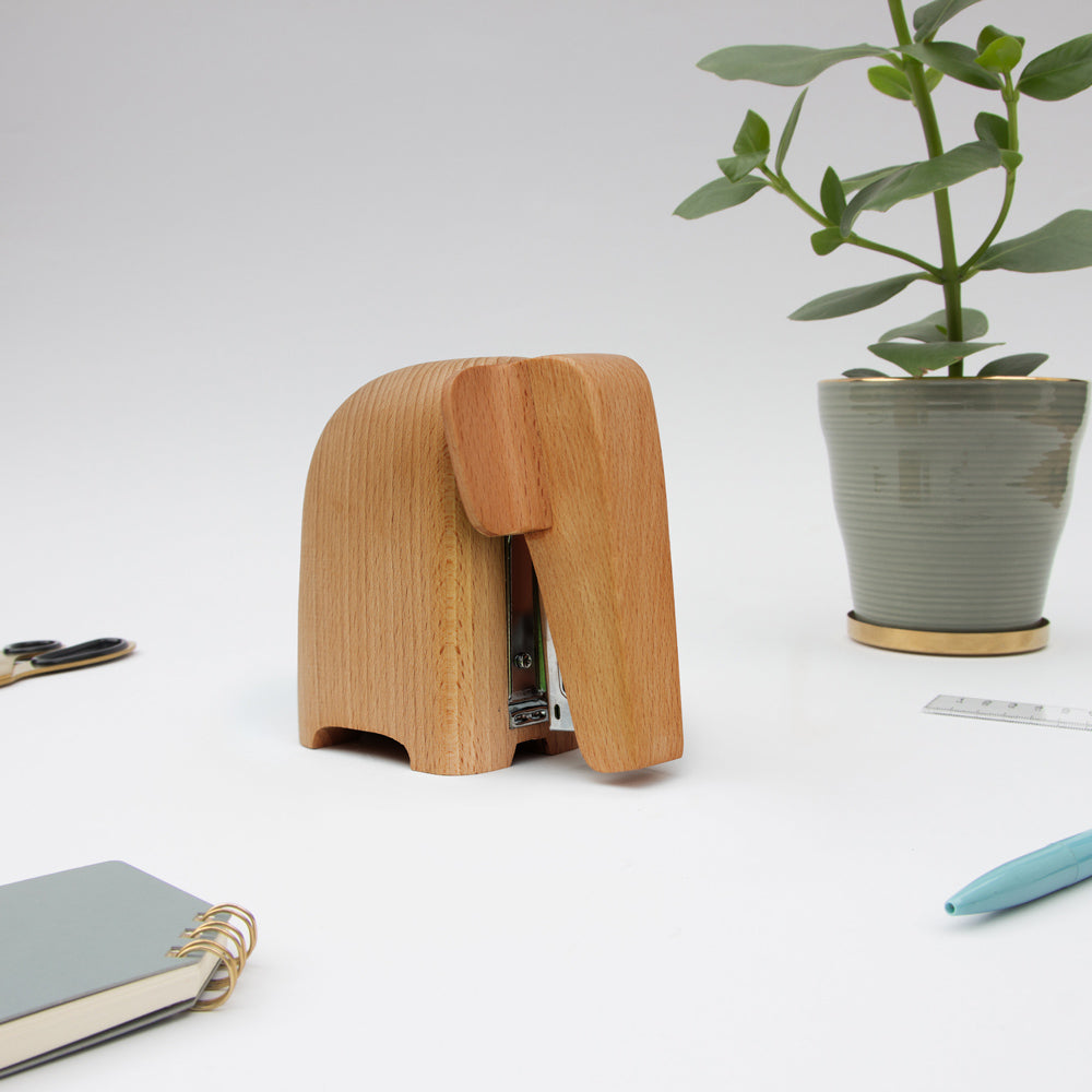 Stapler on desk with accessories.