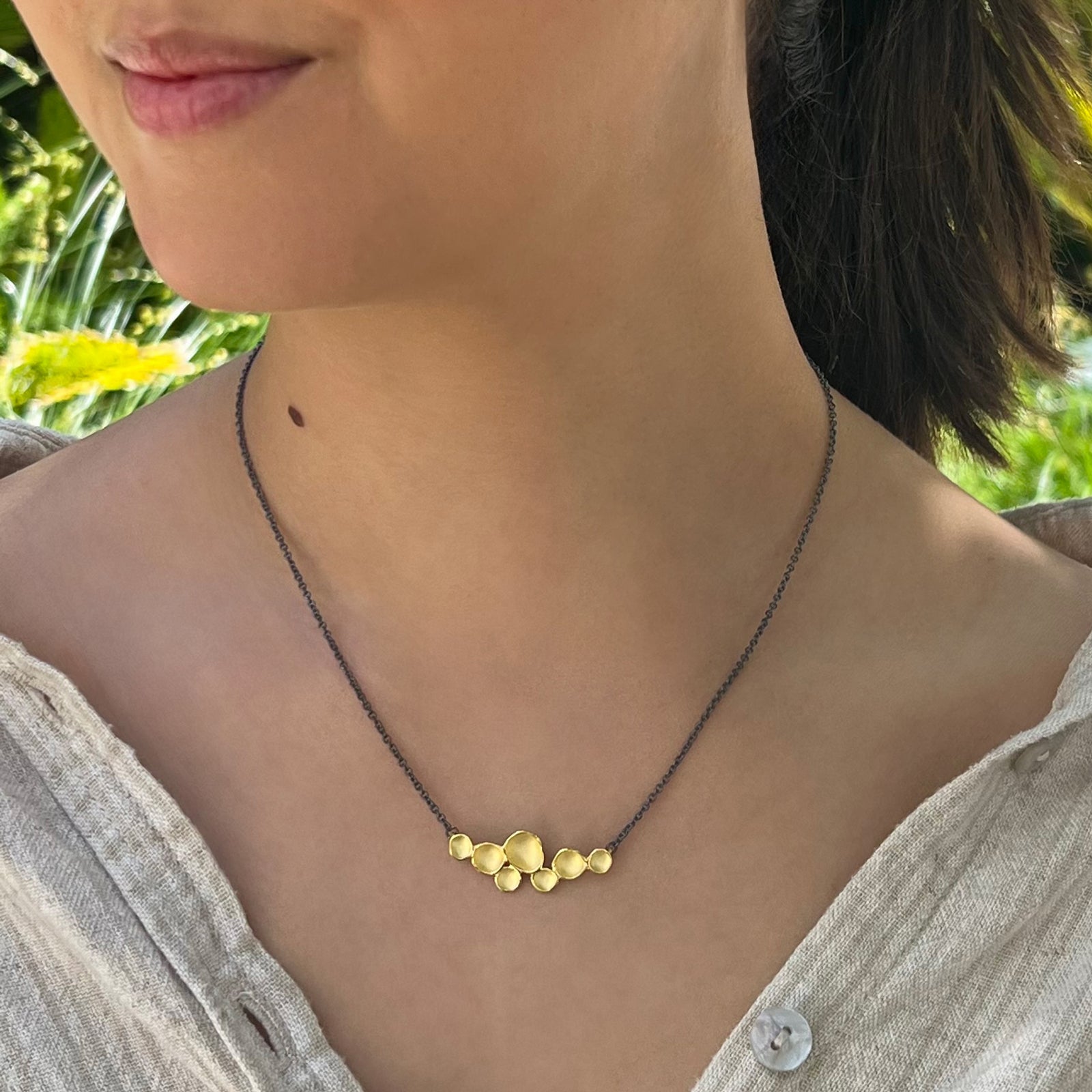 Model wearing necklace.