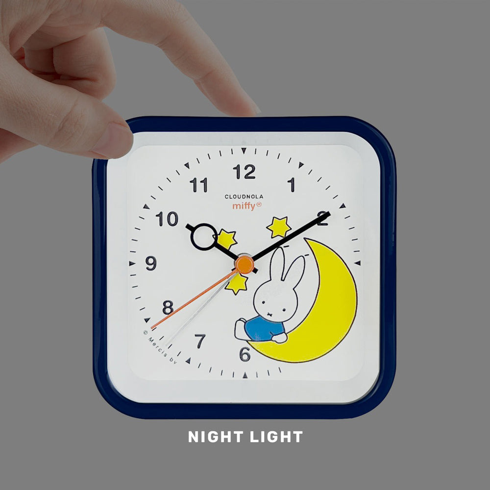 Model turning on night light on clock.