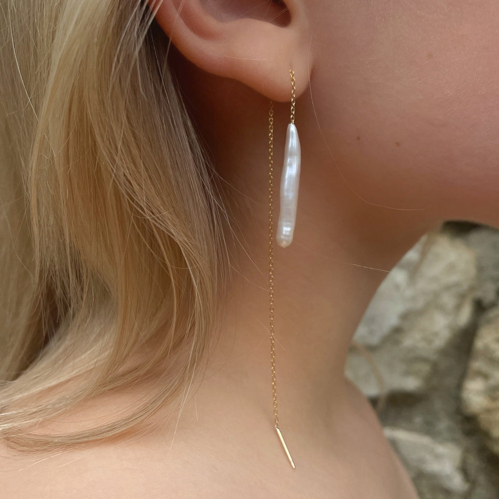Model wearing earrings.