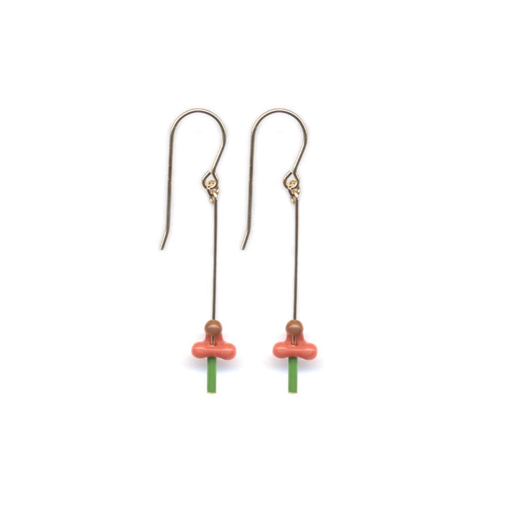 Pair of earrings with pink and green components on a white background