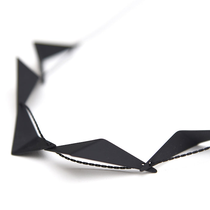 Detail view of geometric necklace.