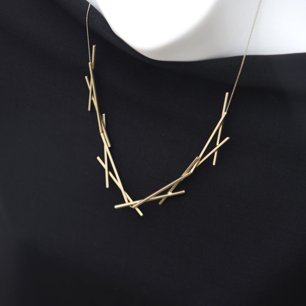 Detail view of gold necklace. 