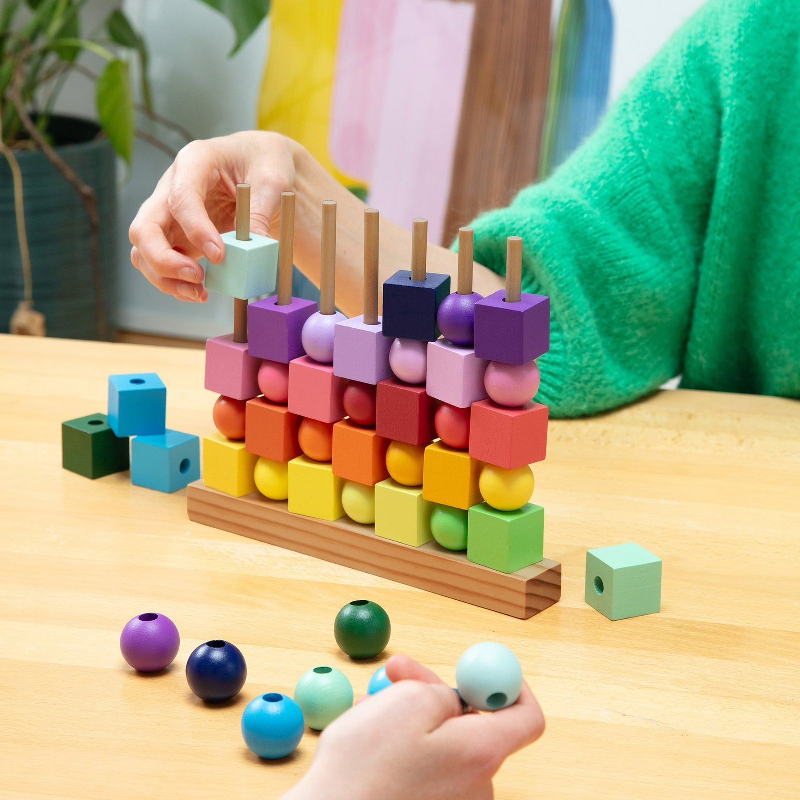 Colorful geometric block tower on a white background