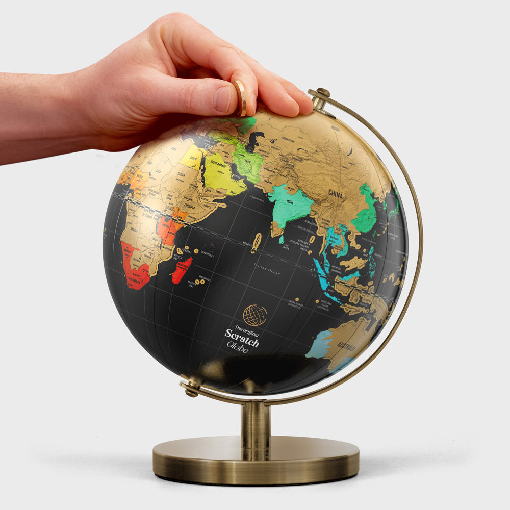 Model scratching globe with coin.