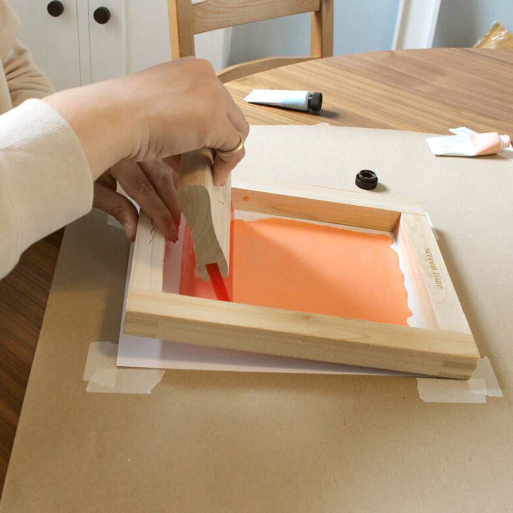 Model using squeegee on screen.