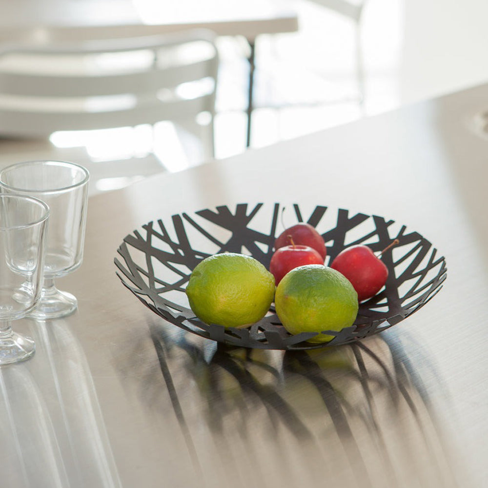 Fruit in bowl on dining table.