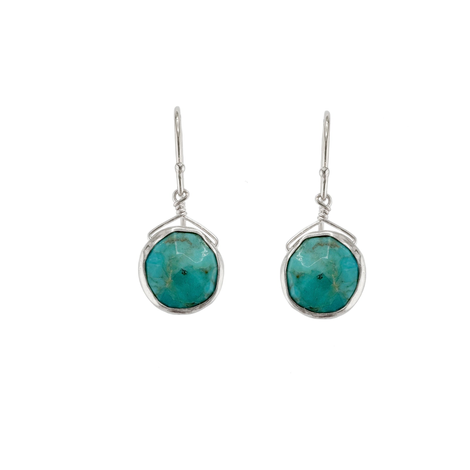 Turquoise stone earrings with silver wire wrapping on a white background