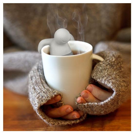 Mr. Tea Infuser inside a cup of tea in a model&#39;s hands.