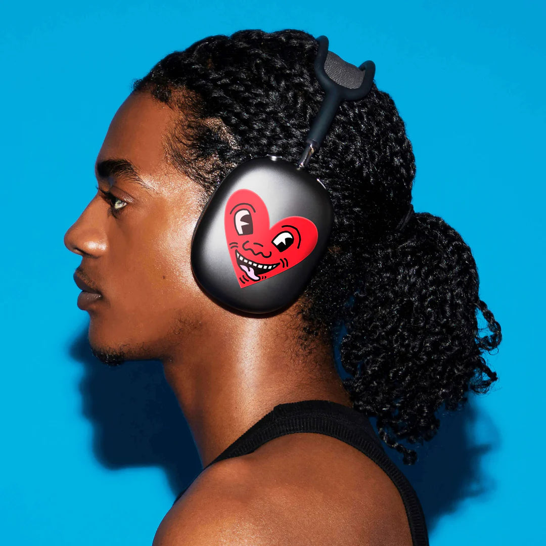 Model wearing headphones with Keith Haring Heart Sticker.