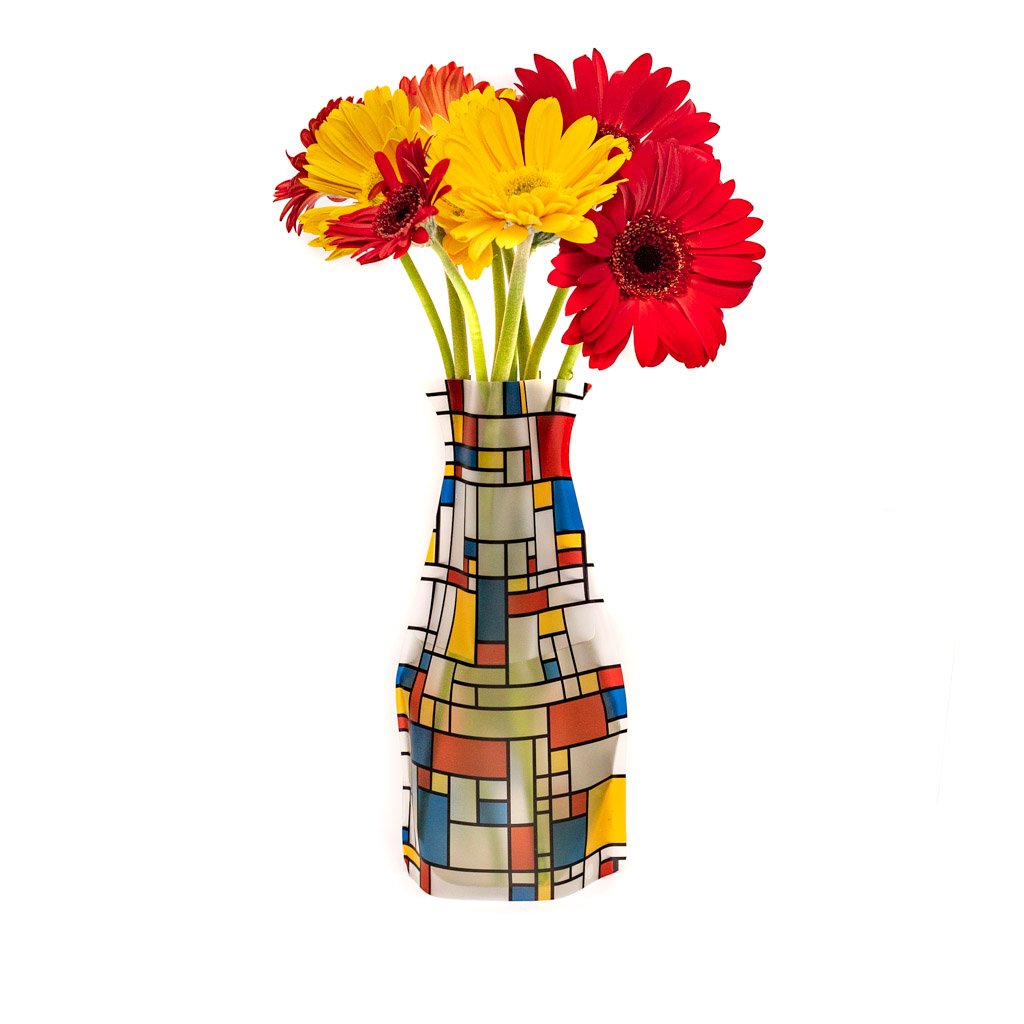 The Mona Vase displayed with red and yellow flowers.
