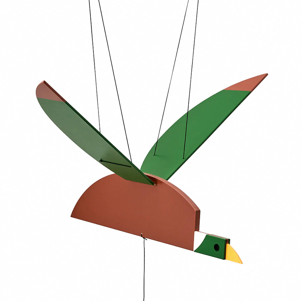 Wooden duck mobile, painted brown with green wings, green face, and yellow beak, hanging from black strings.