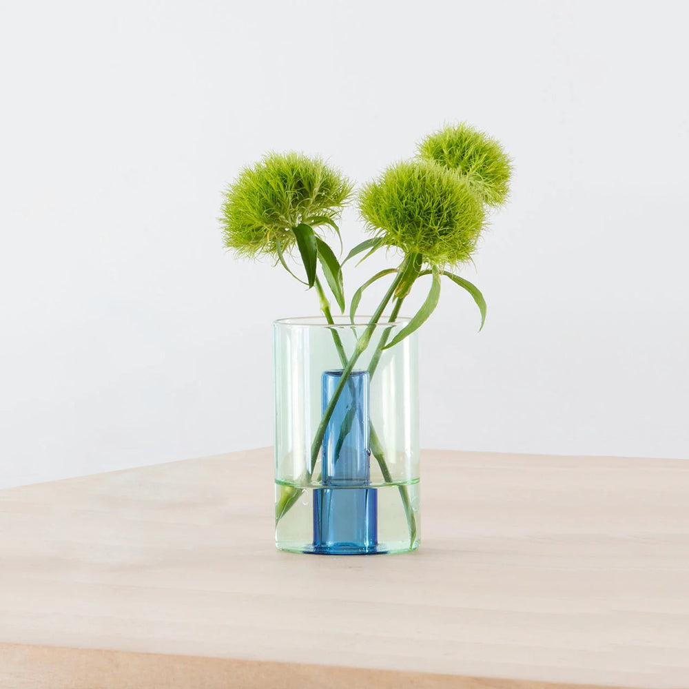 Small Reversible Vase with plants on table.