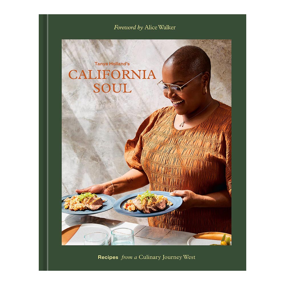 Cover of Tanya Holland's California Soul, green hardcover with full color image of Holland holding two plates of food.
