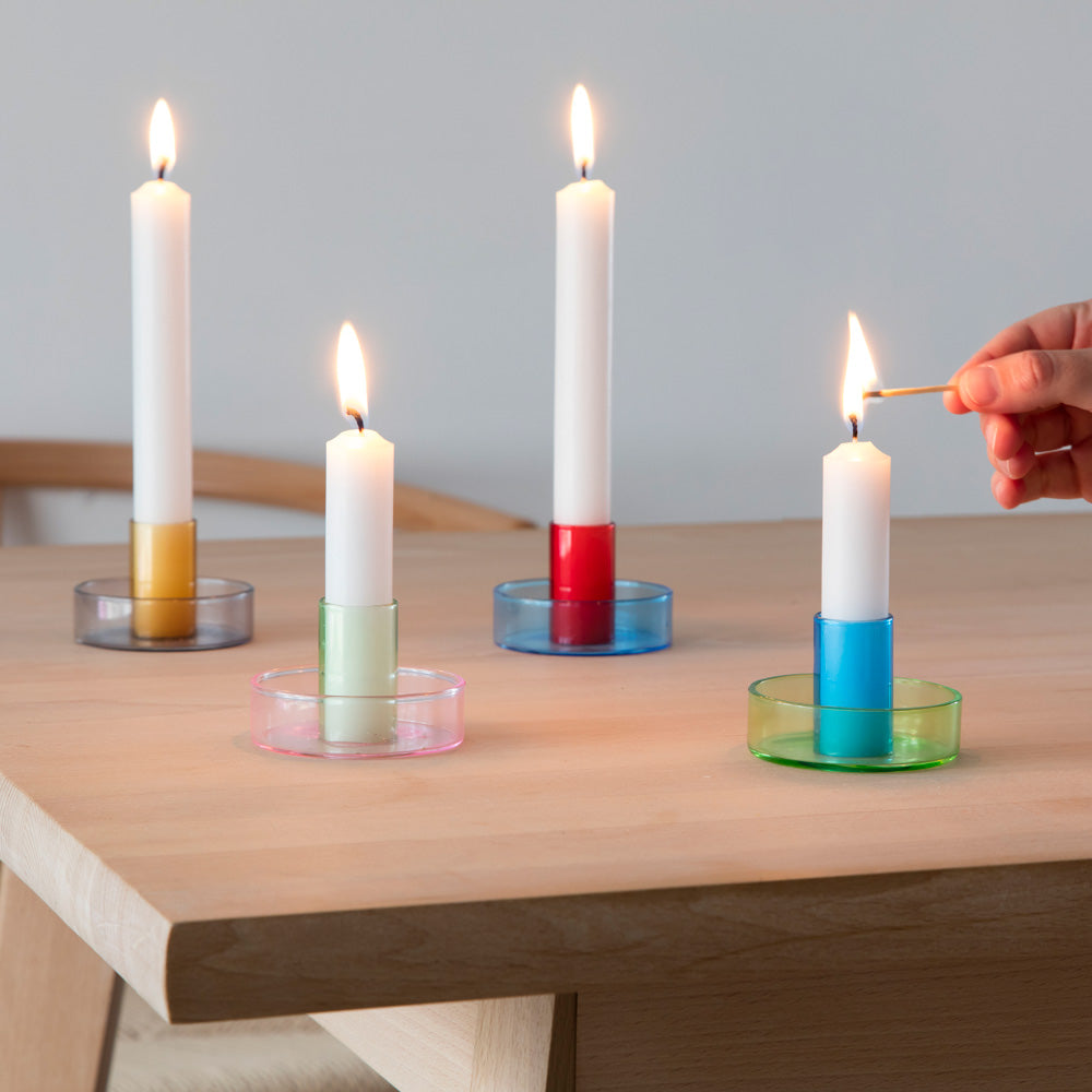 Lighted candlesticks with holders.