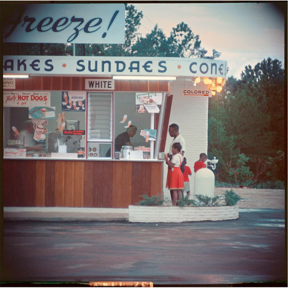 Black family buying ice cream from a diner.