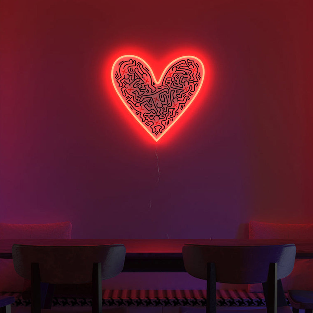 Yellowpop Keith Haring &#39;Dance Love&#39; neon light in dark room, above dining table.