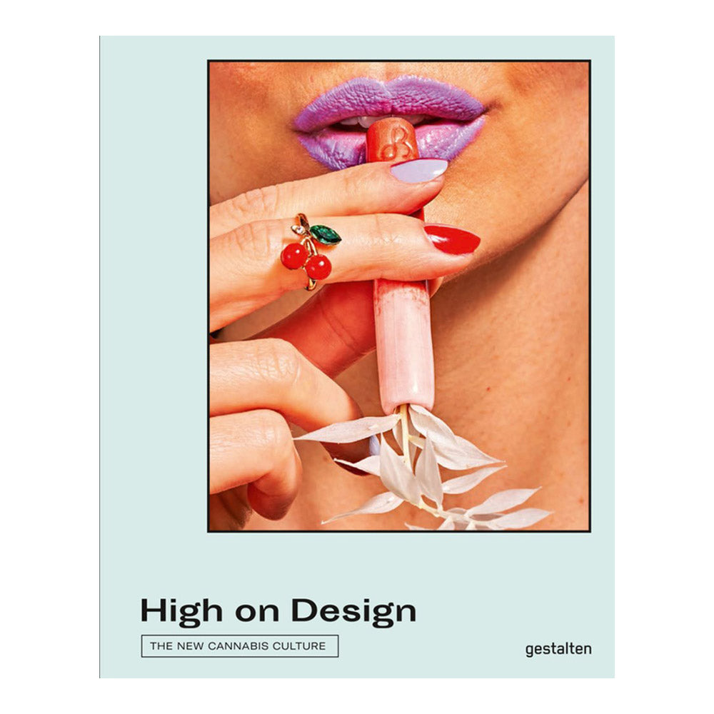 Cover of &#39;High on Design&#39;. Woman holding small pipe with pointed, painted fingernails, purple lipstick, and cherry ring.