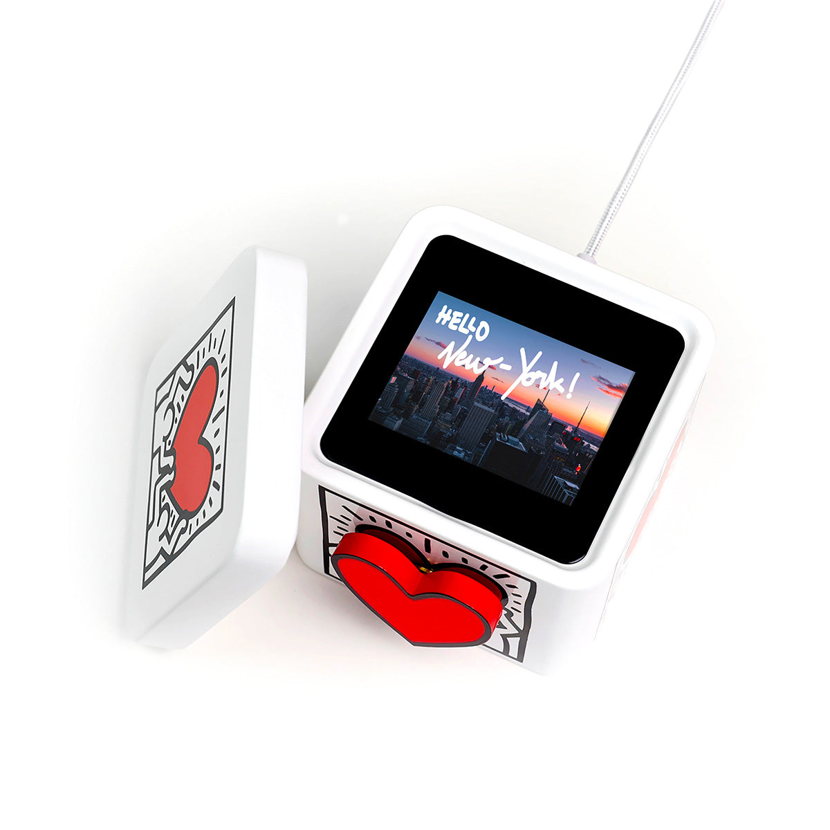 Photo of opened Keith Haring Lovebox, with custom message displayed on screen, on white background.