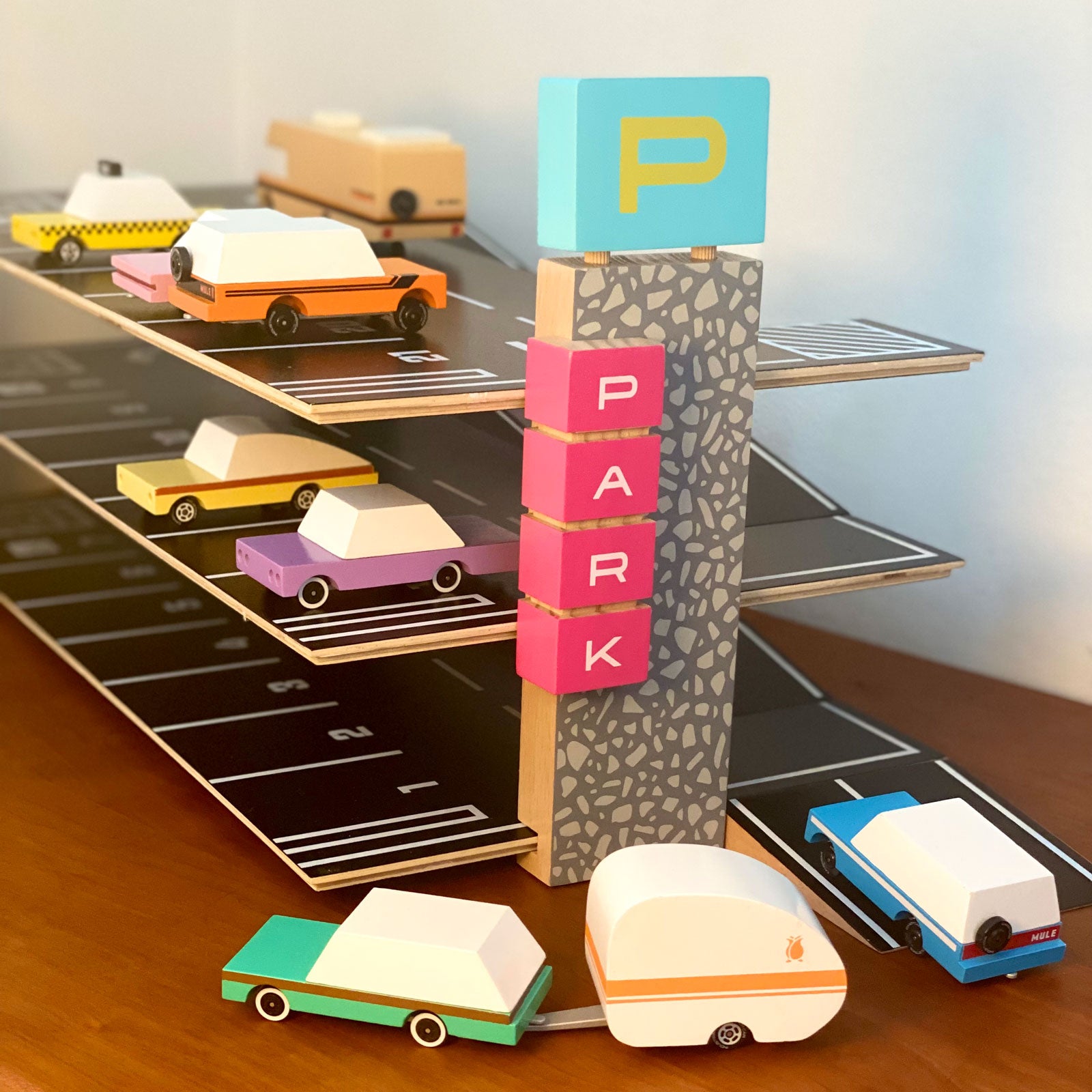 Magnetic Parking Garage by Candylab with two cars attached.
