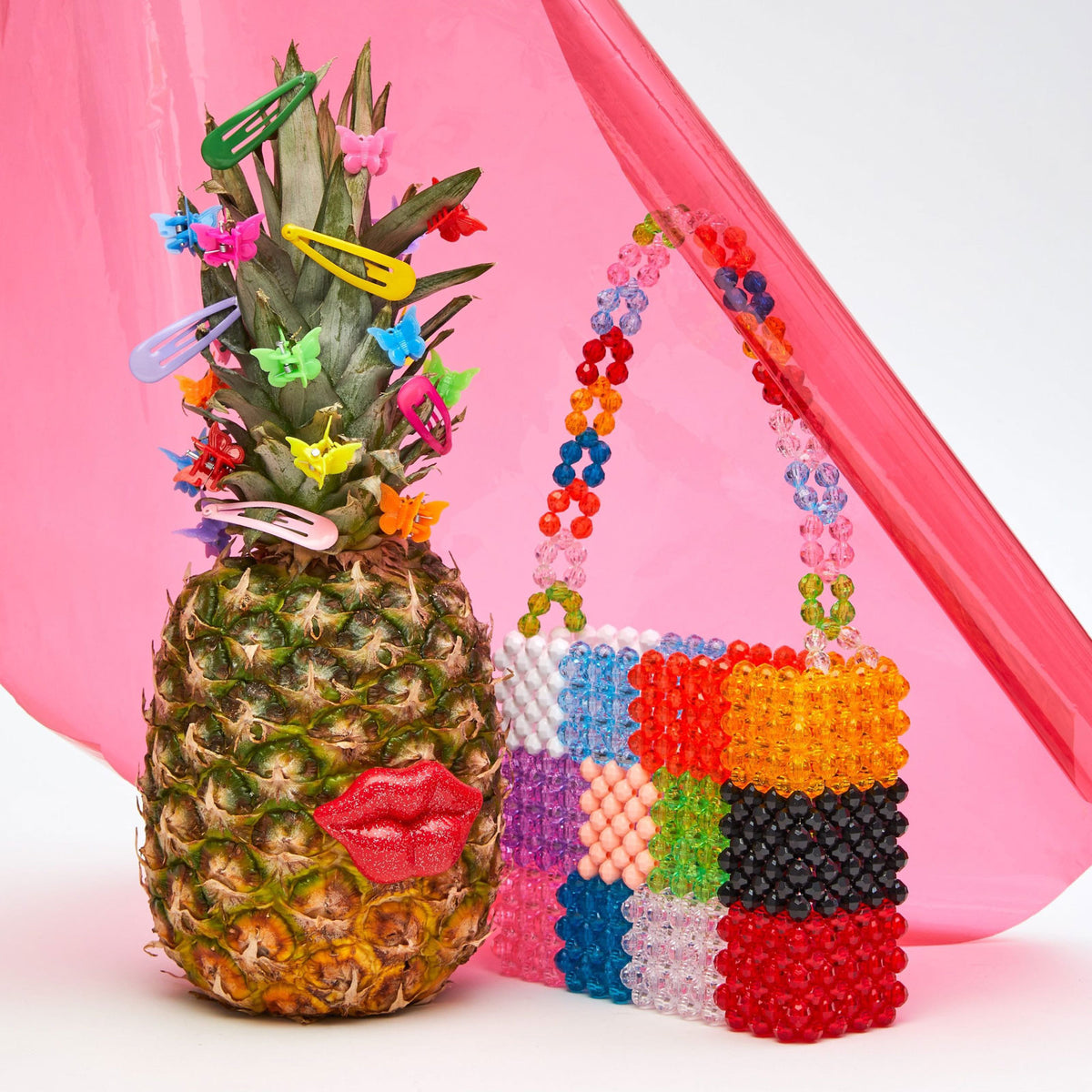 The Mini Ash Bag next to a decorated pineapple.