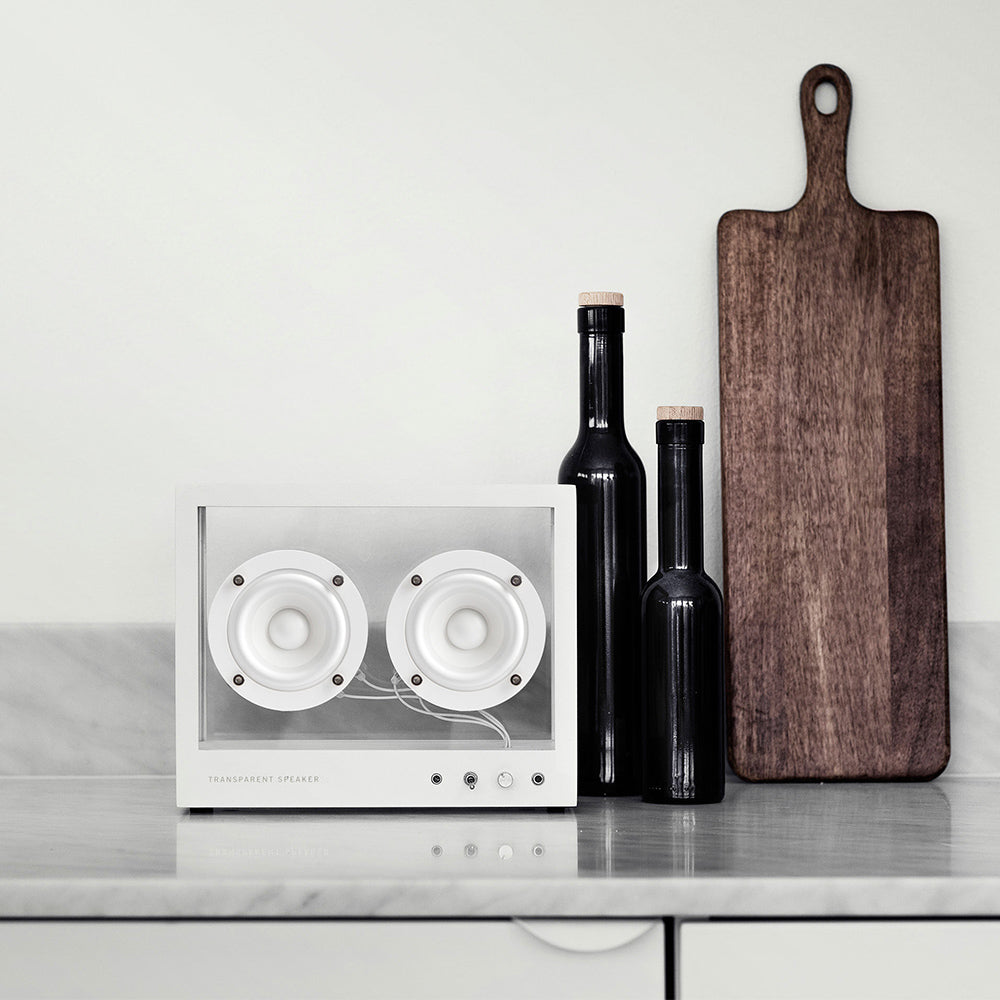 Small Transparent Speaker: White displayed with oil bottles and a cutting board.