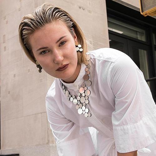 The Iskin Sisters: Silver Abstraction Necklace worn by a model.
