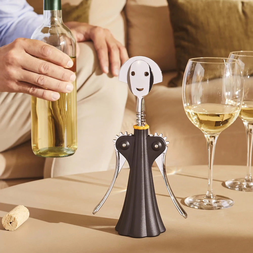 Corkscrew on table with wine.