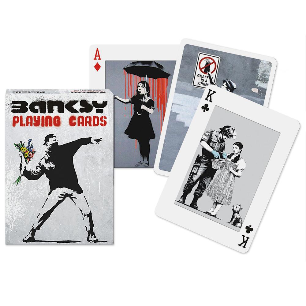 The Banksy Playing Cards box alongside three of its cards.