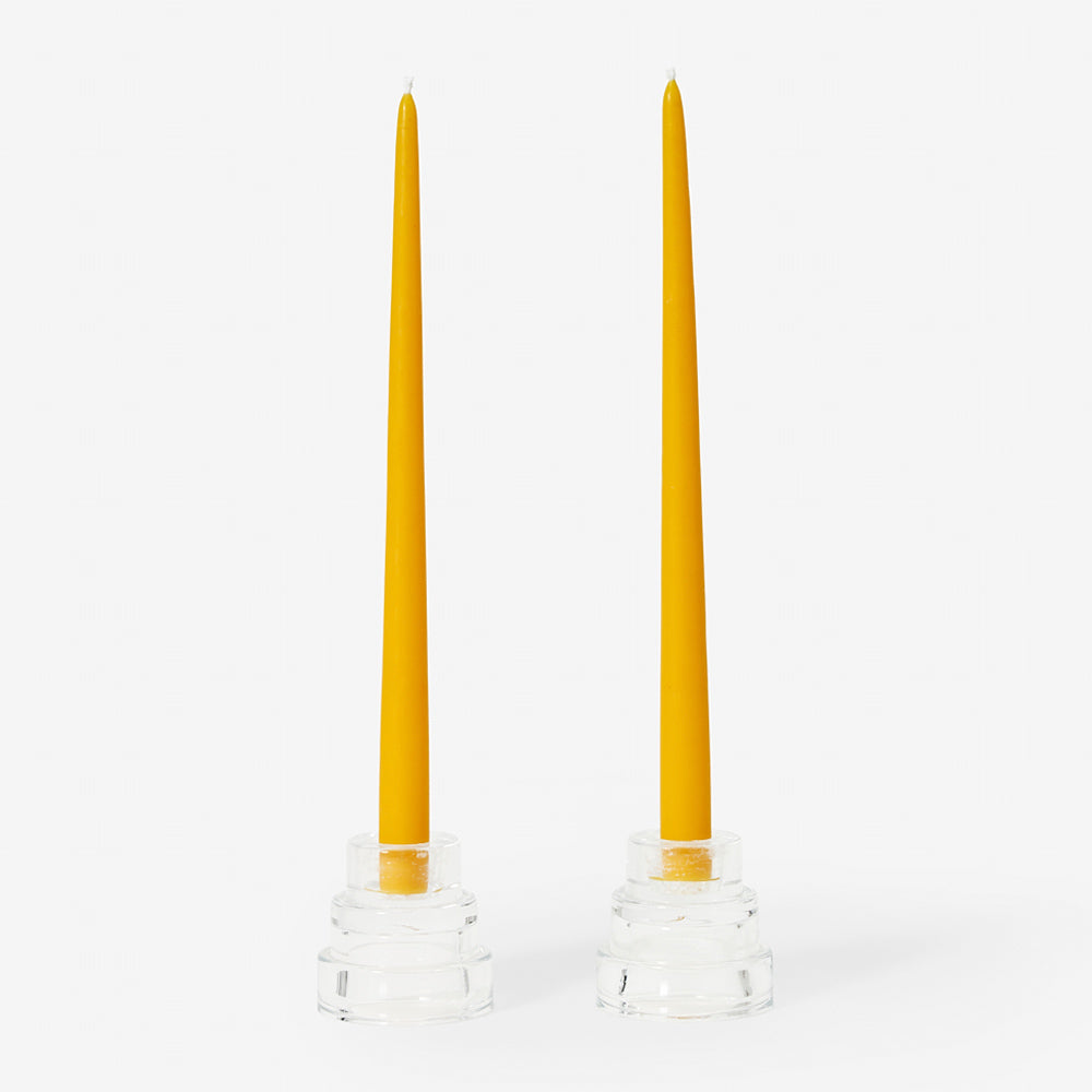 Two beeswax candles on display.
