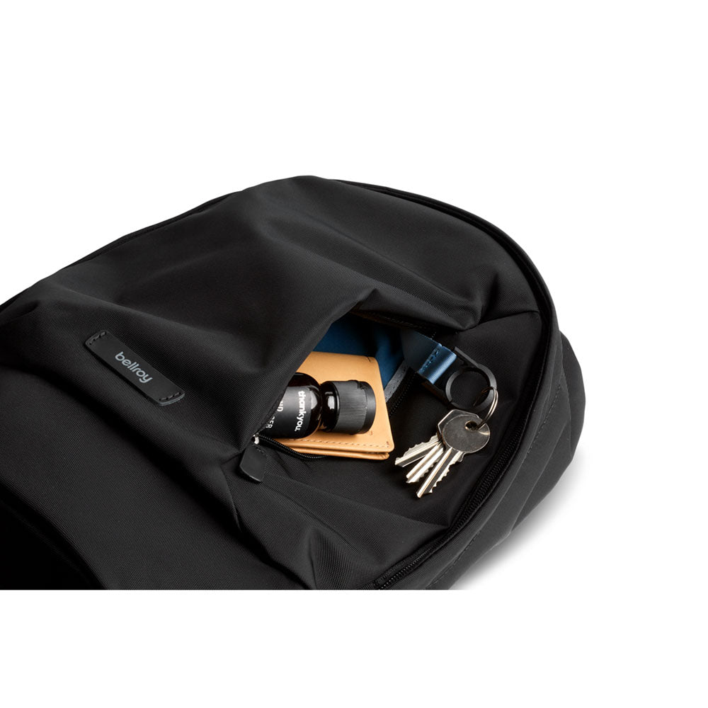 The black Classic Backpack Compact&#39;s quick access pocket opened, showing off its built-in key clip.