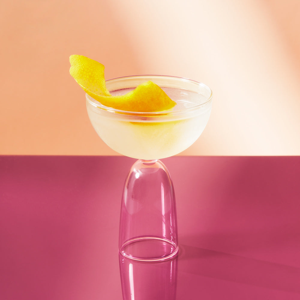 Martini in coupe glass with a lemon peel.