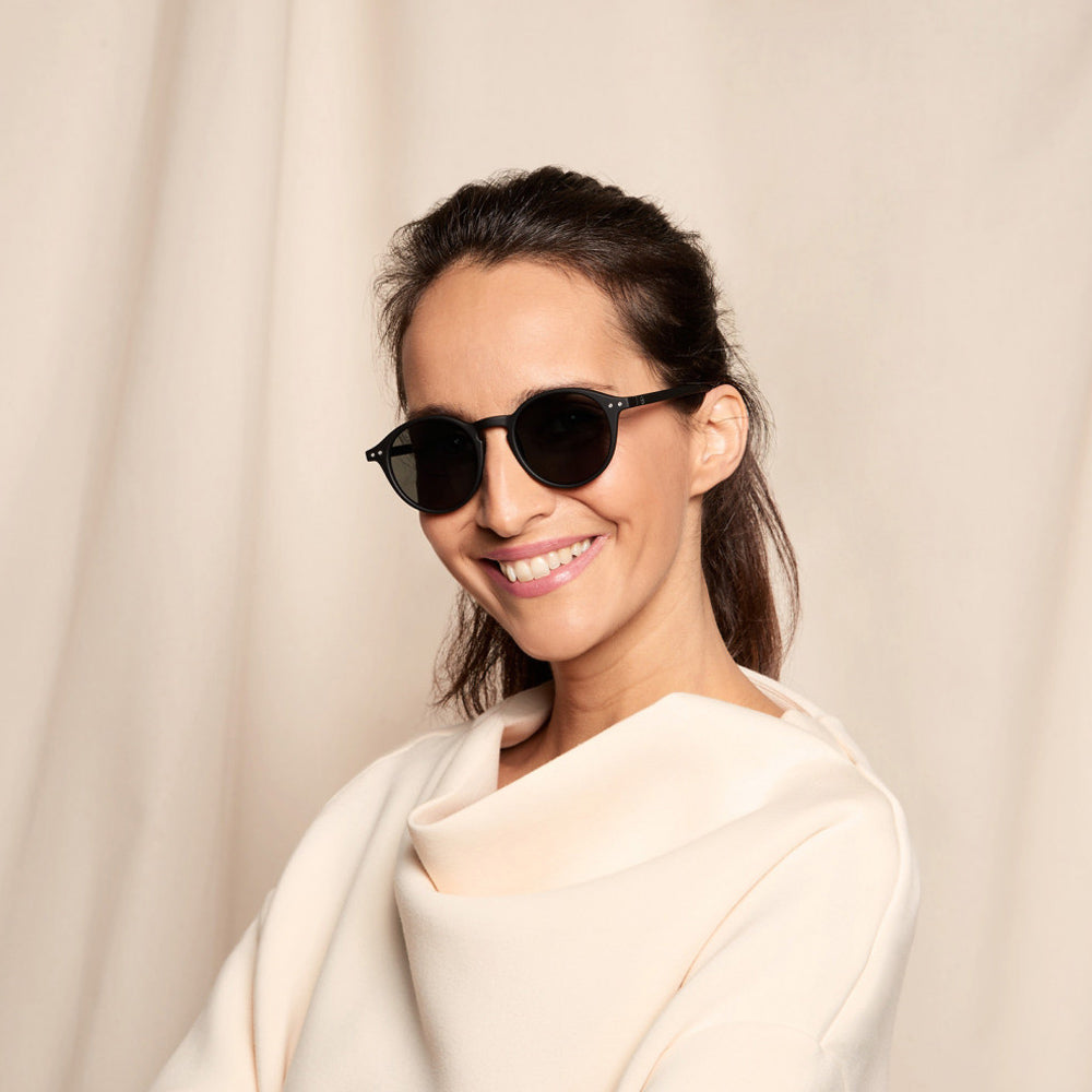 Model smiling wearing sunglasses.