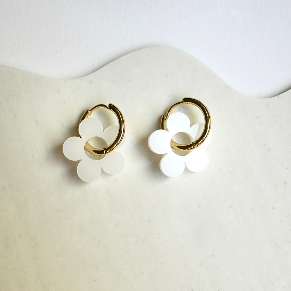 Daisy Huggie Hoop Earrings by Shape & Color, white daisies with gold-plated hoops.