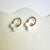Daisy Huggie Hoop Earrings by Shape & Color, white daisies with gold-plated hoops.