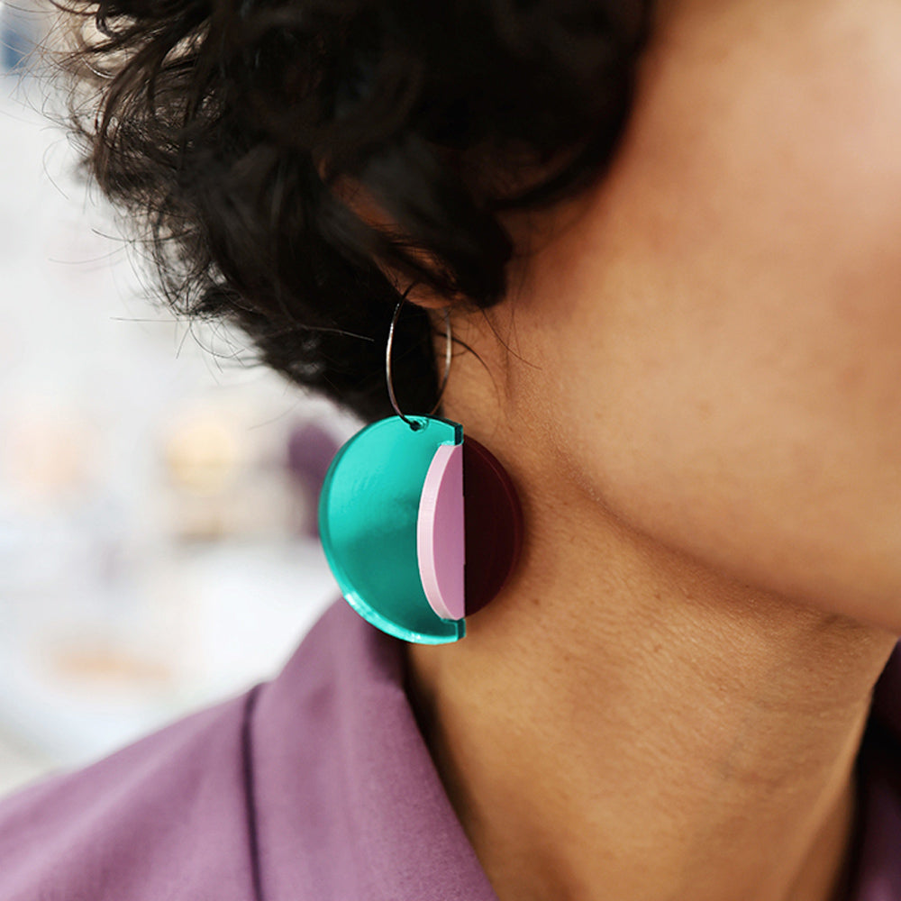 Close-up model wearing earrings.