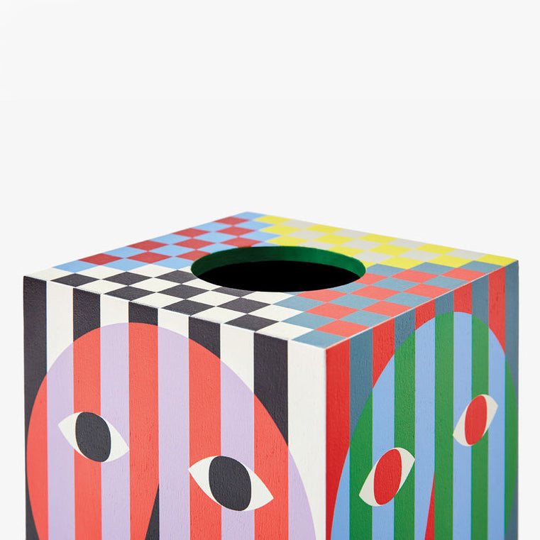 Hand pulling tissue out of the Everybody Tissue Box.