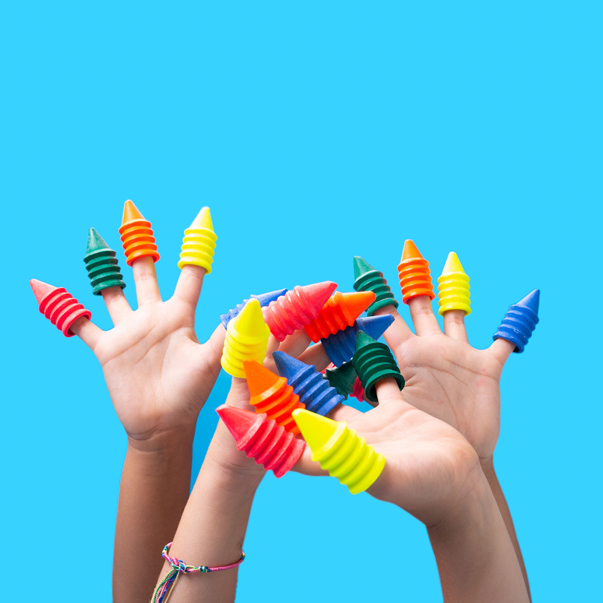 Several Finger Crayons on children&#39;s fingers.