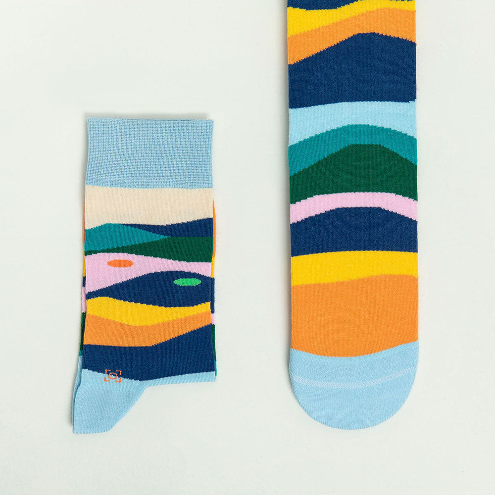 A pair of Gauguin Socks displayed to show off the artwork.