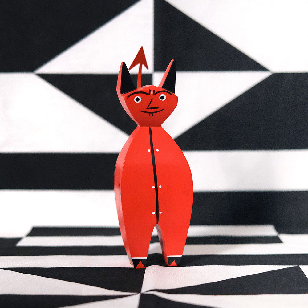 Girard Wooden Doll: Little Devil on a Girard geometric table runner.