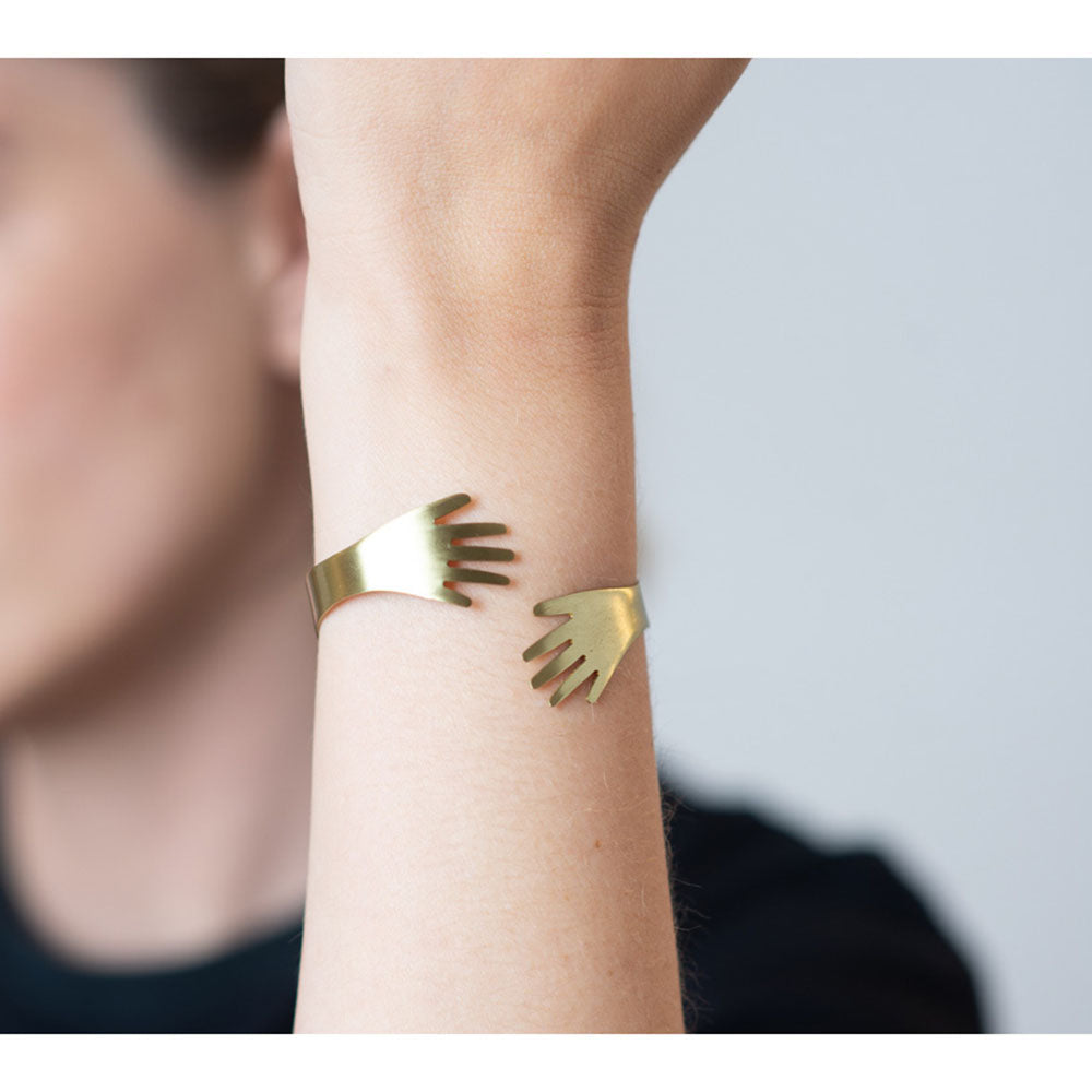 A model wearing the Give Me A Hug Bracelet on their wrist.