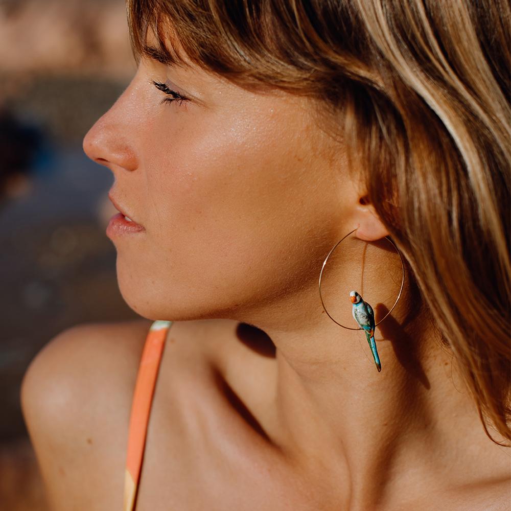 A model wearing a Nach: Blue + Green Parrot Hoop.