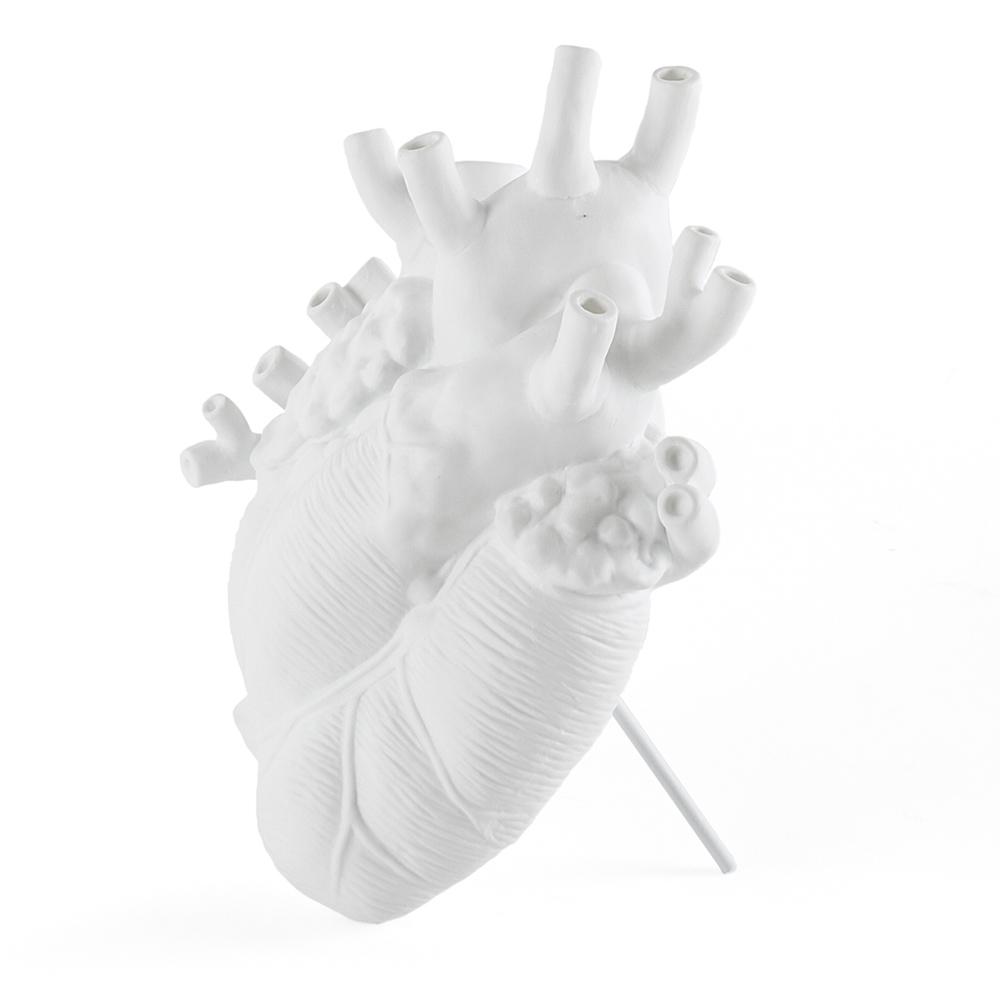 The Porcelain Heart Vase: White displayed on its included stand.