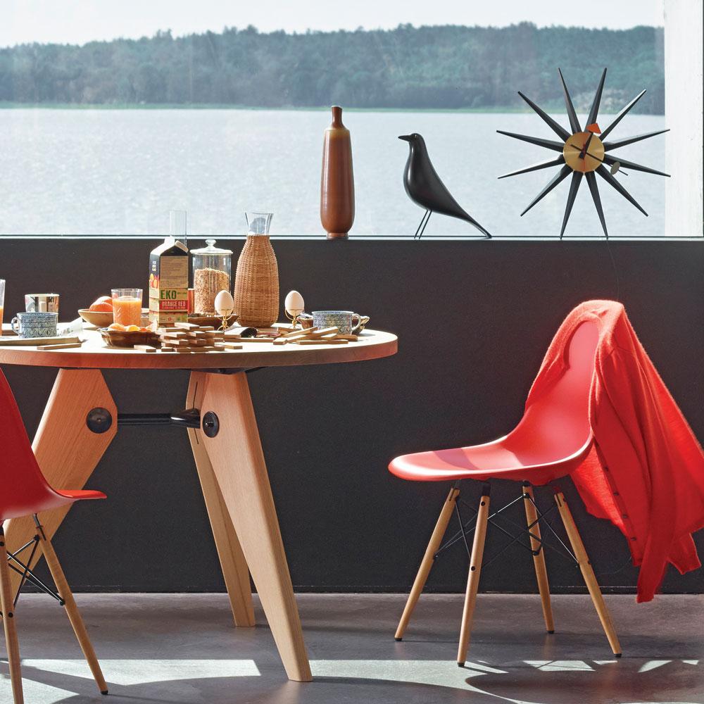 The Eames House Bird: Black displayed on a shelf with a clock.