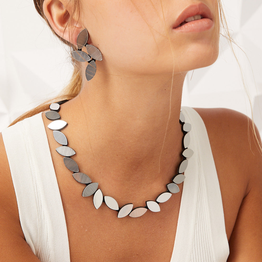Close-up model wearing necklace.