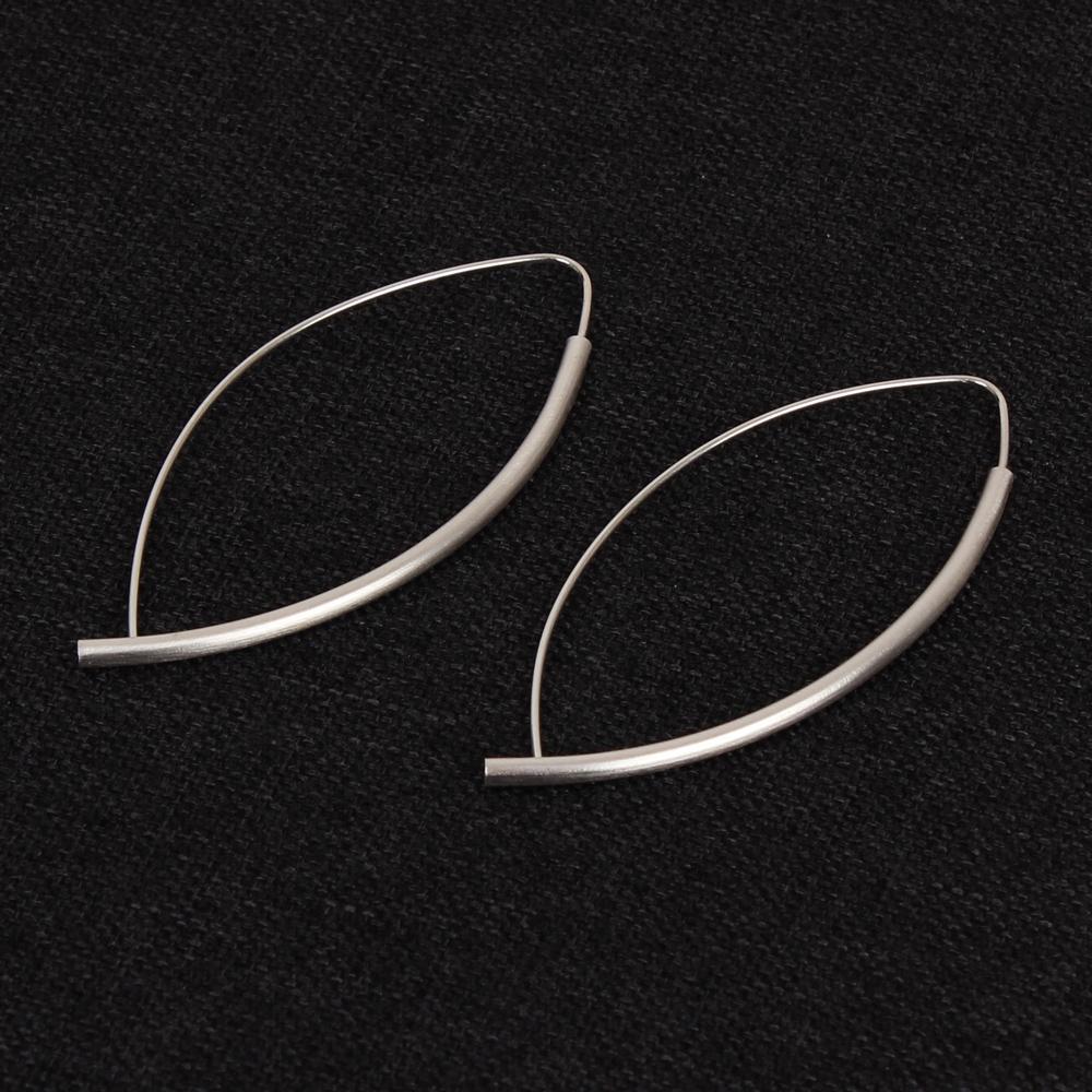 Kelim Asymmetrical Hoop Earrings on display.