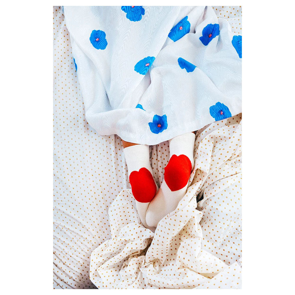 Model in Love You Socks, eggshell with red heart on heels,  with white and blue floral dress.
