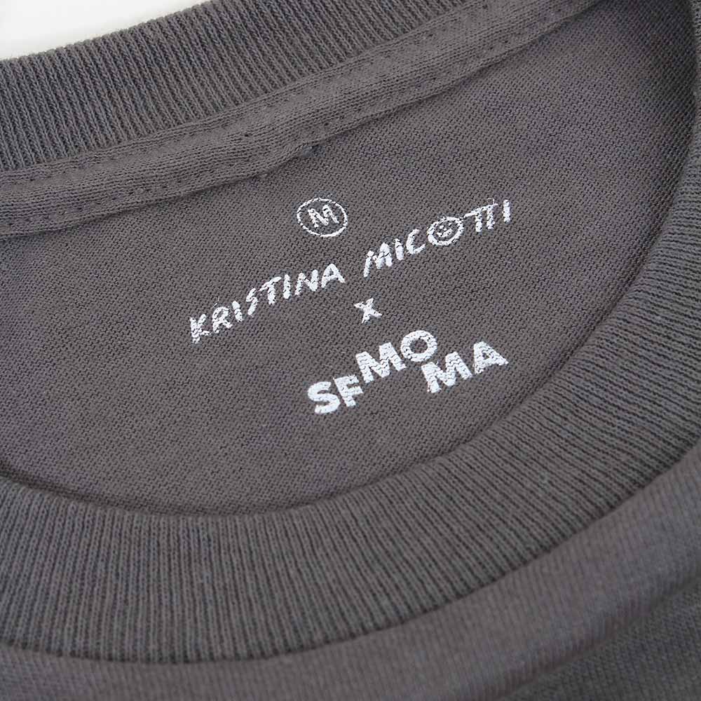 Closeup of screenprint label on Kristina Micotti x SFMOMA long sleeve t-shirt.